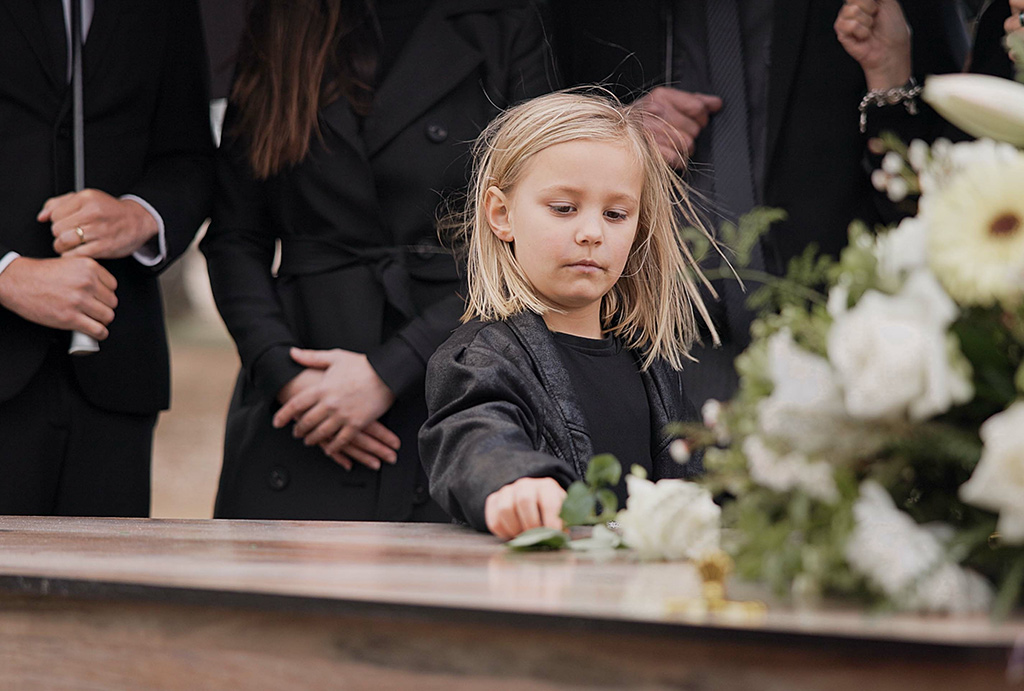 child at funeral burial