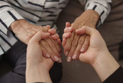 women holding hands grief support