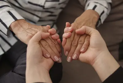 women holding hands grief support